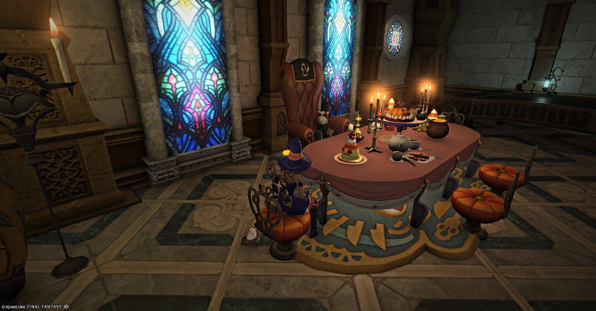 The banquet table on a patterned stone floor, tall stained-glass windows along the wall and pumpkin stools drawn up to it