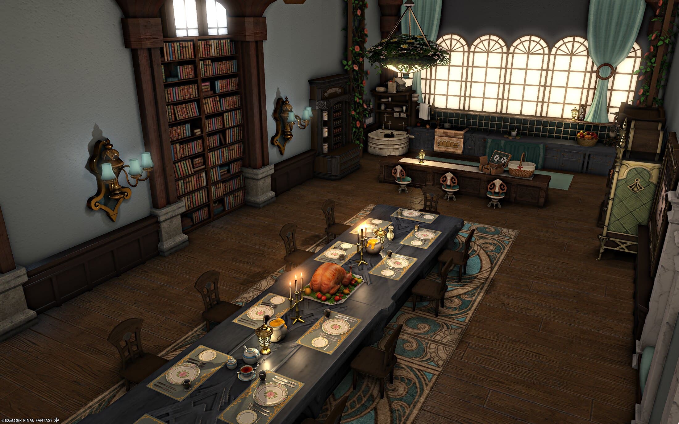 The dining room and kitchen from above — a long blue-grey table laid with place settings, candelabras and a roast dodo on a platter, bookshelves and brass sconces along the wall, and beyond it the kitchen's arched windows, tiled counter, rose trellises and stools at the island