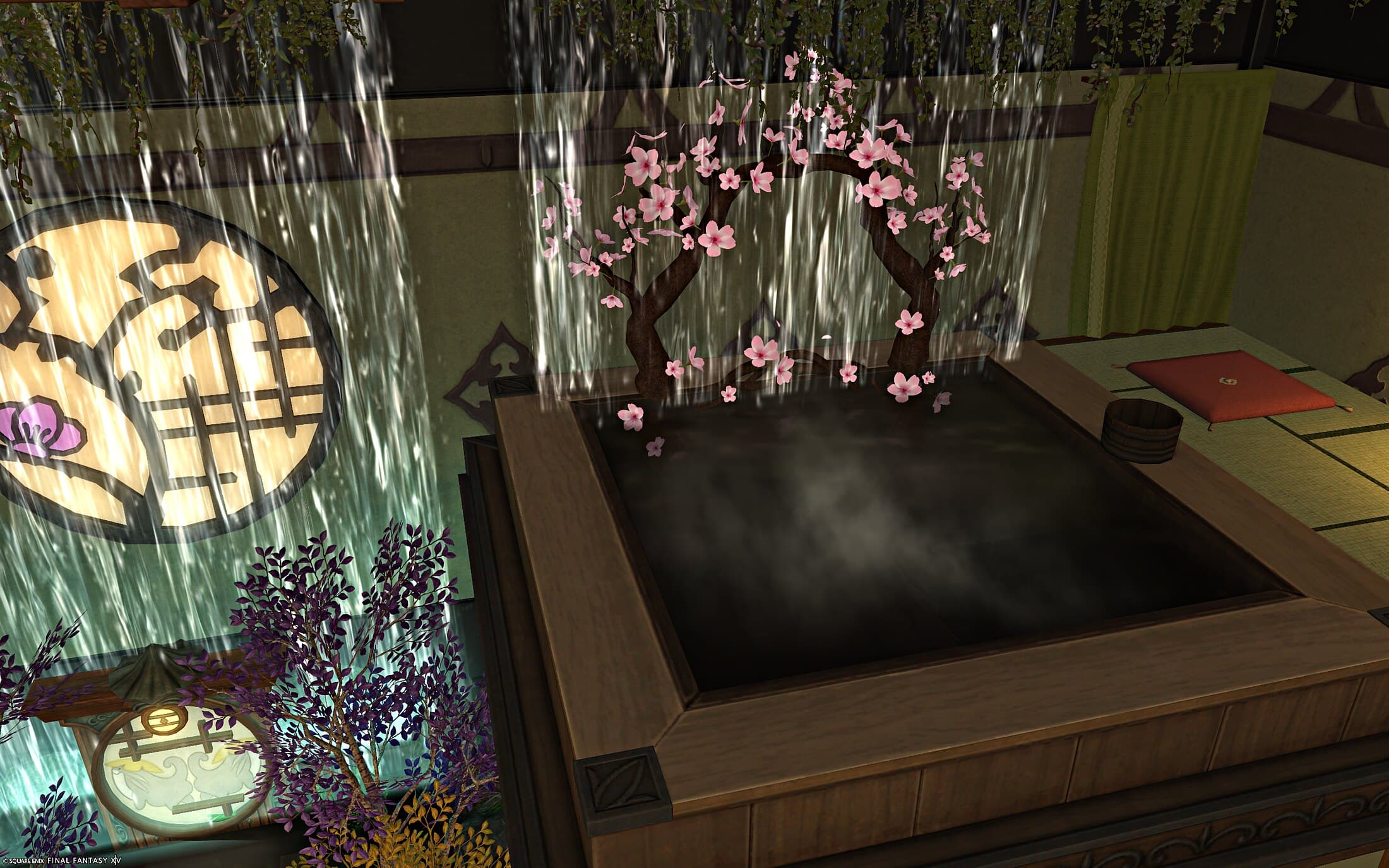 An upper bath with a cherry blossom tree arching over the water, a waterfall falling behind, a wooden bucket and a red cushion on the tatami beside it