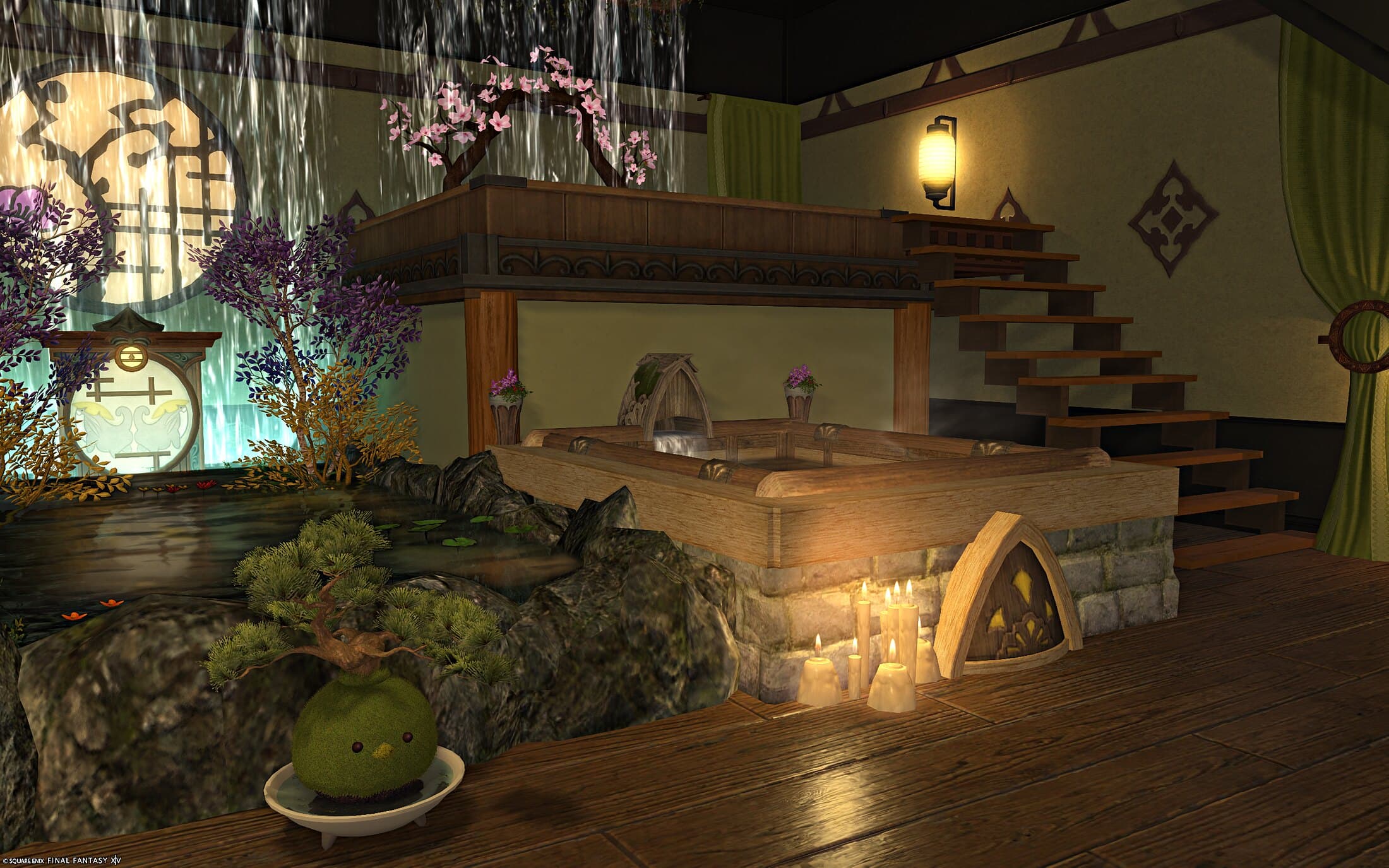 A lower bath on a stone base with a stack of lit candles at its corner, a bonsai in a dish at the pond's edge, the stairs and the round window beyond