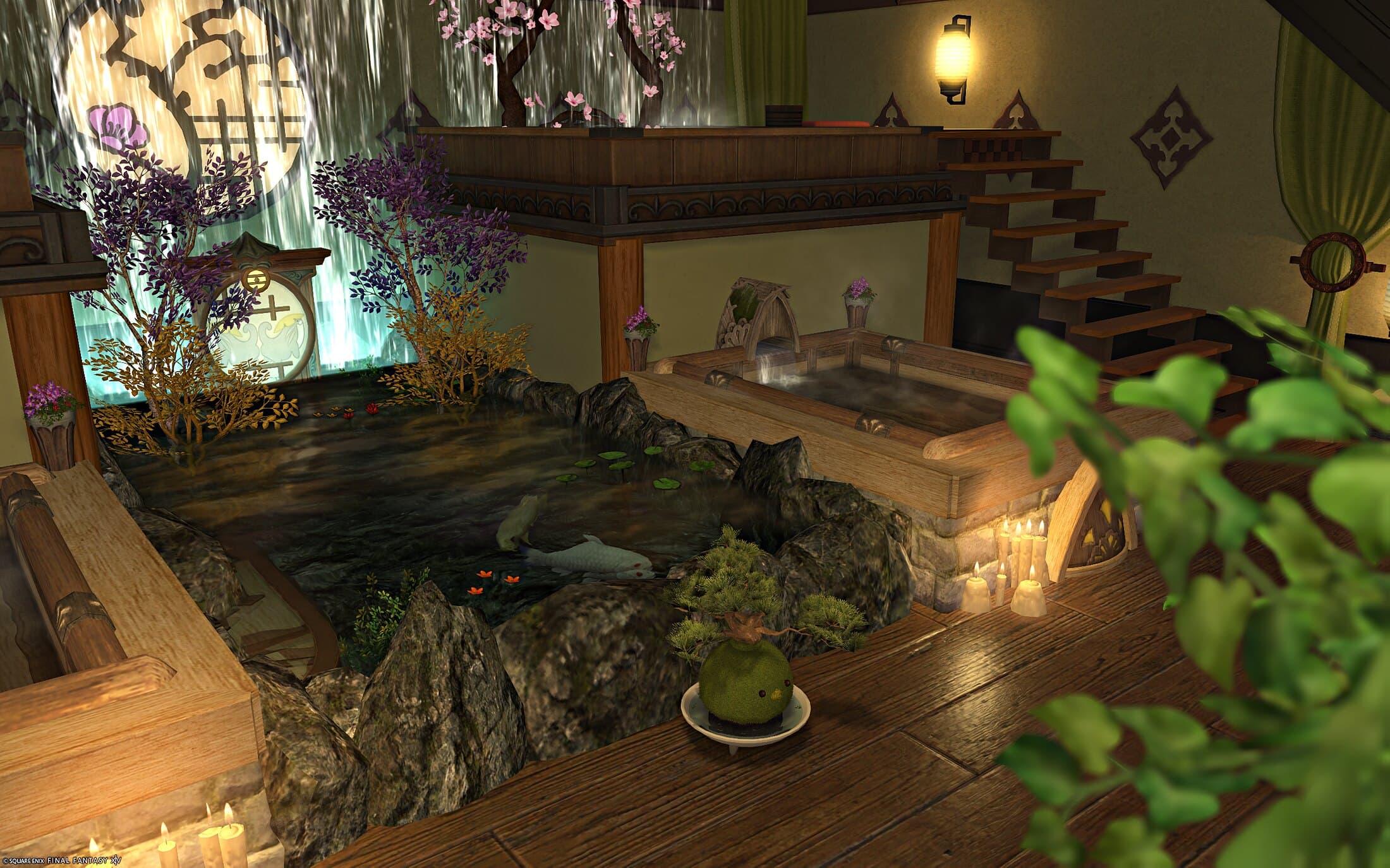 The lower bath and the koi pond seen past a potted plant, a bonsai in a dish on the rocks and the stairs rising at the right