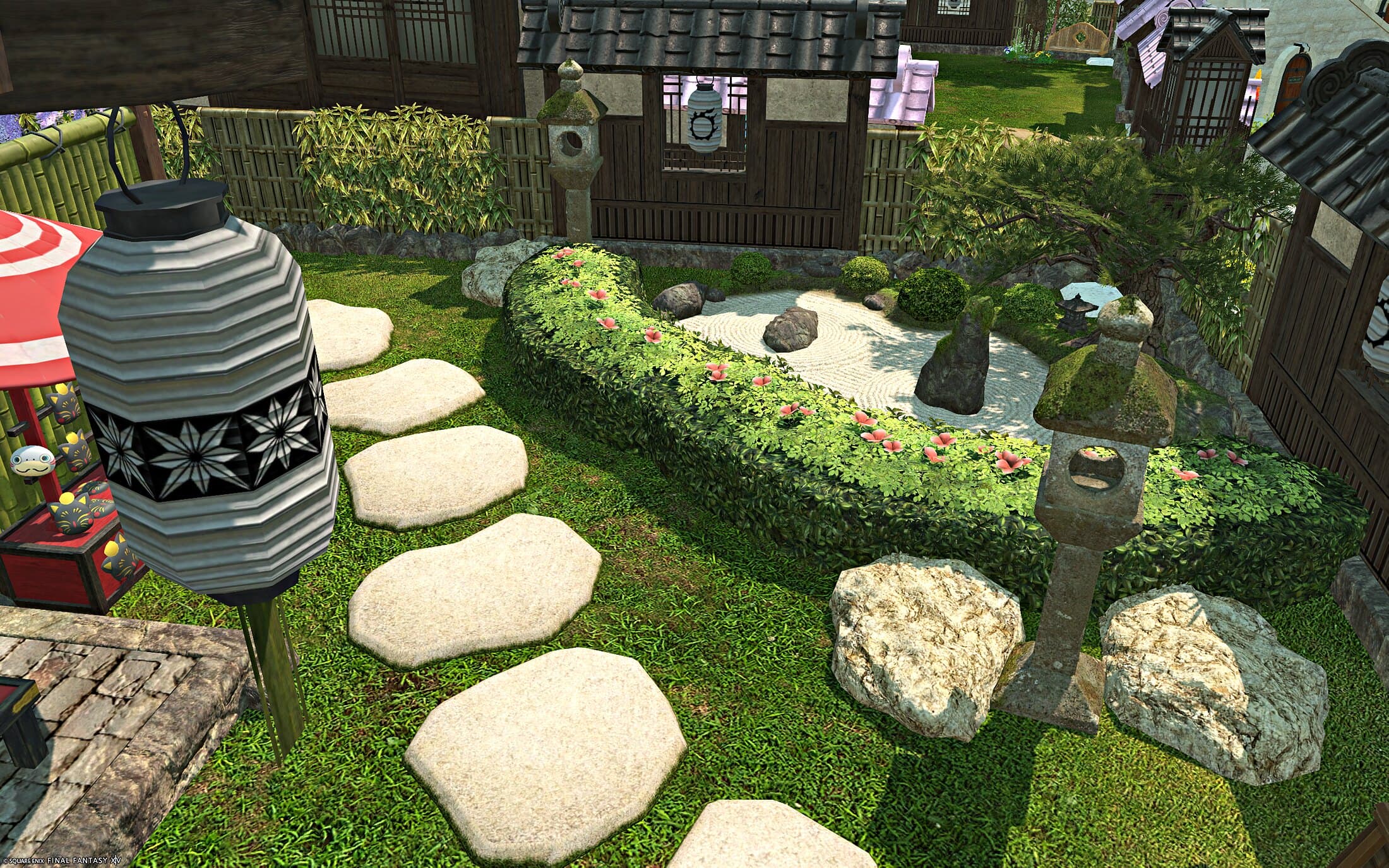 The garden outside — stepping stones across the lawn, a raked gravel garden edged in hedging, stone lanterns and a paper lantern in the foreground