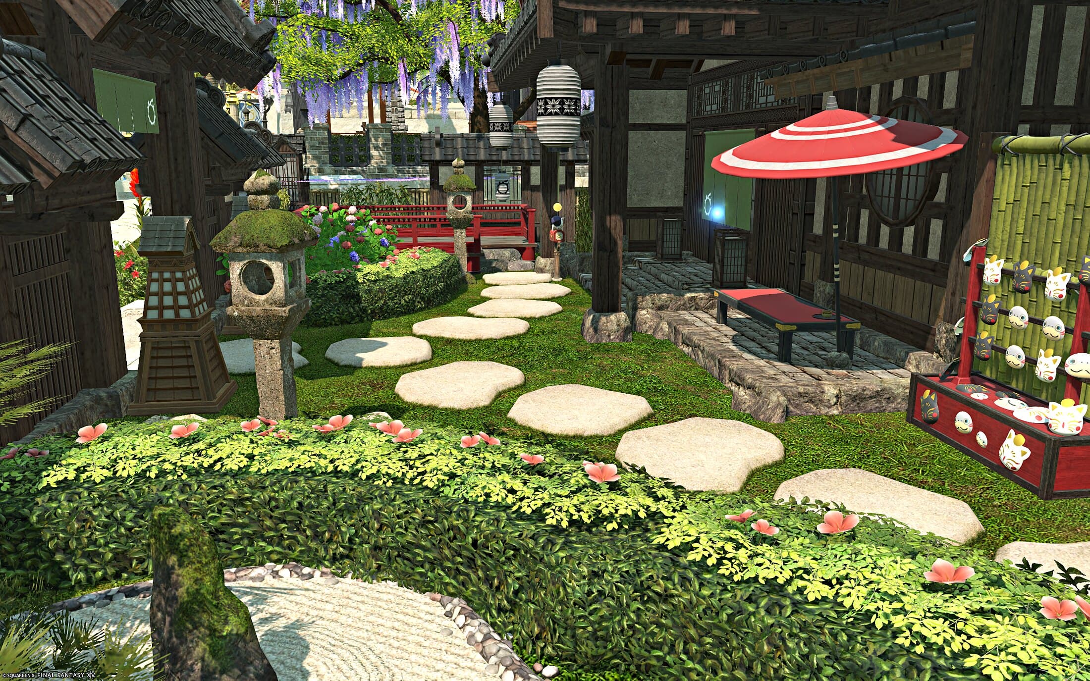 A stepping-stone path past stone lanterns and flowering hedges to a bench under a red parasol, a stall of lucky cats beside it