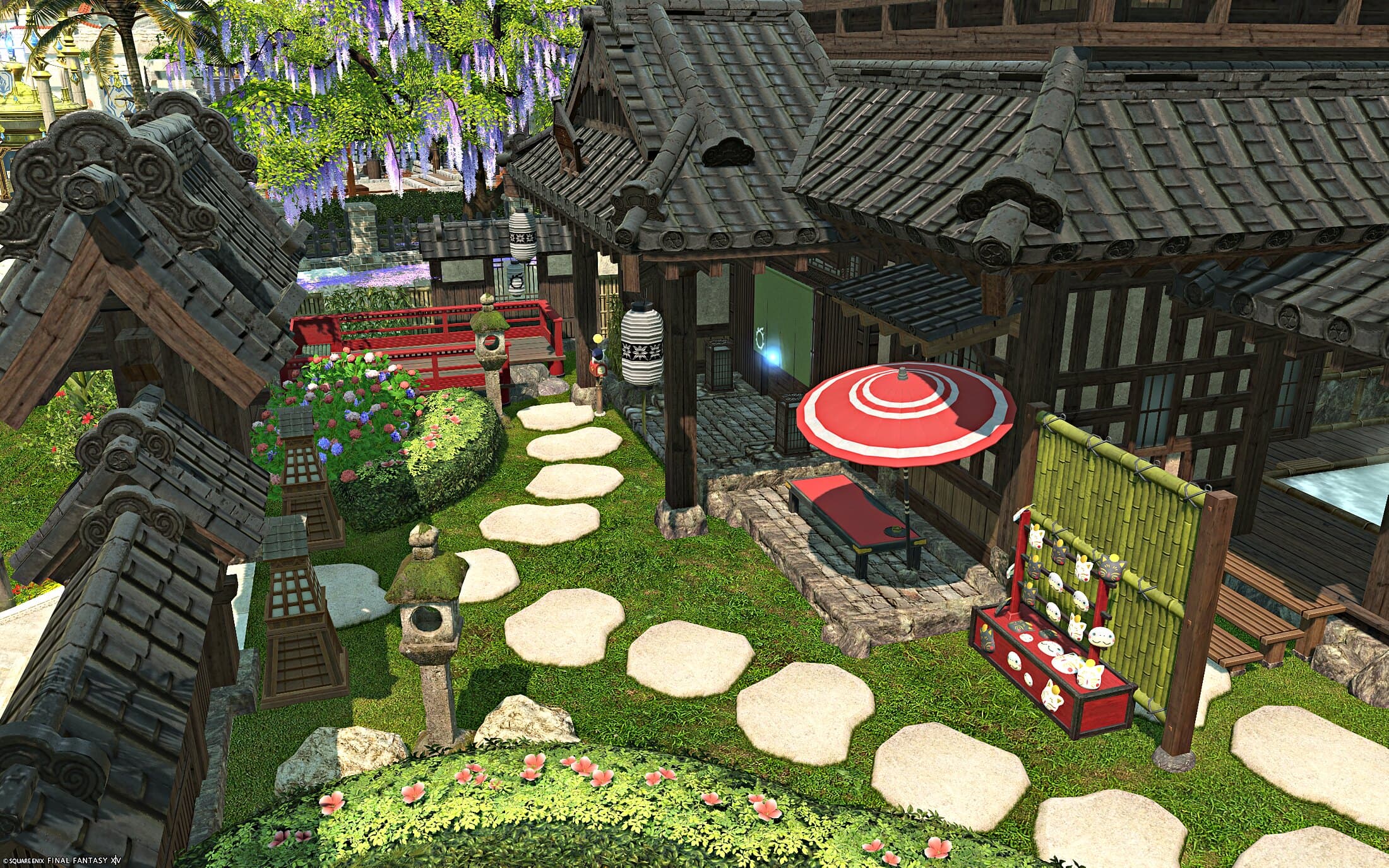 The garden from above — tiled roofs, the stepping-stone path, the red parasol and the lucky cat stall, wisteria hanging beyond the wall