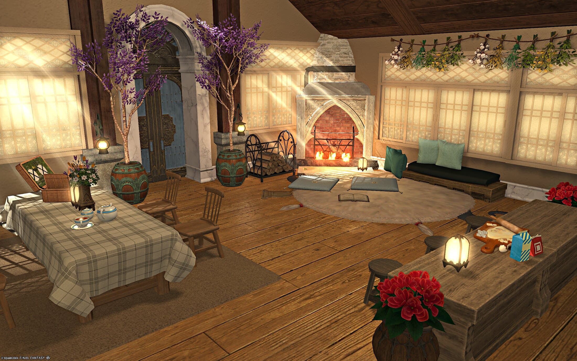 The main floor seen from the dining table — a wisteria-flanked blue door, a stone fireplace, floor cushions and a sofa, with building blocks and gift boxes on the table nearest the fire