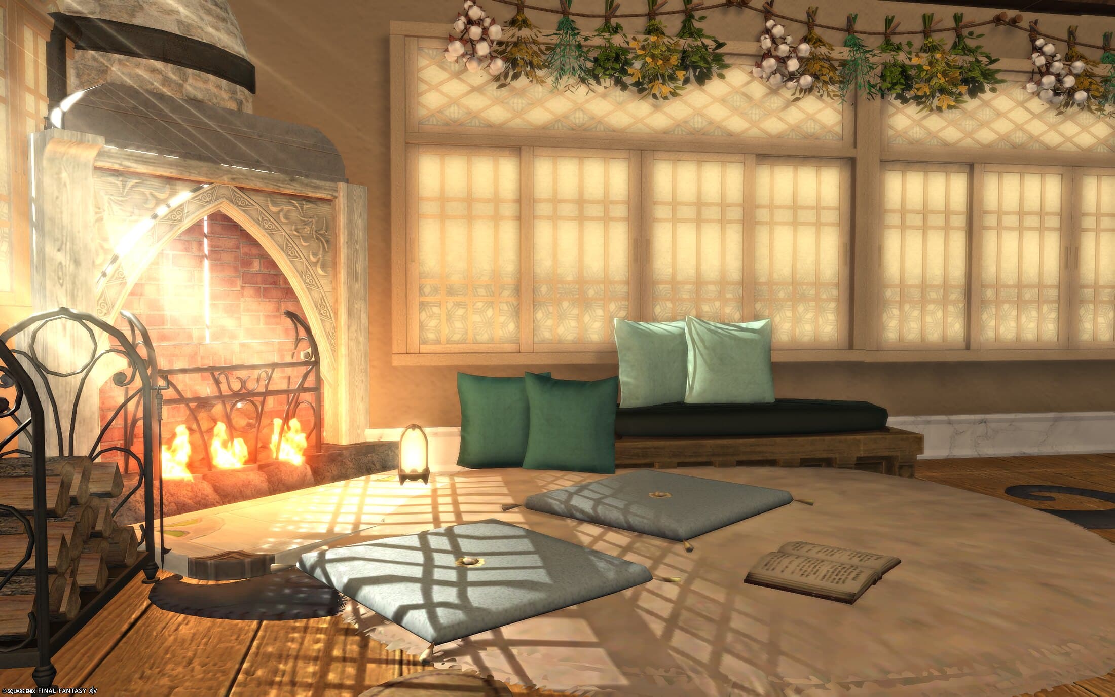 The fireplace close up, its arched stone surround lit from within, blue floor cushions and a green-cushioned sofa arranged in front of it