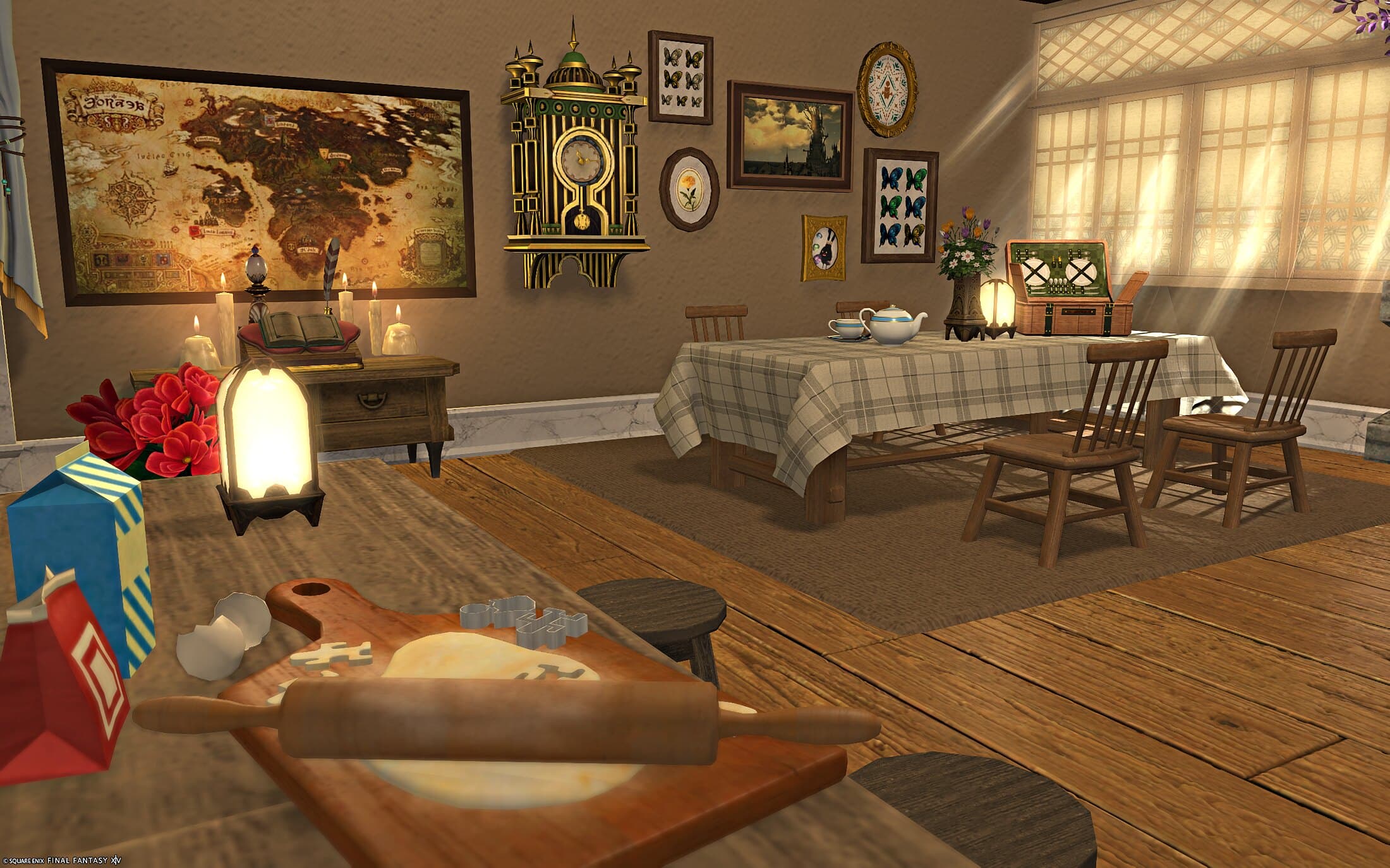 The dining table from the kitchen side, cookie cutters and a rolling pin on a board of dough in the foreground, a wall of framed prints, a map and a gilt clock beyond the table