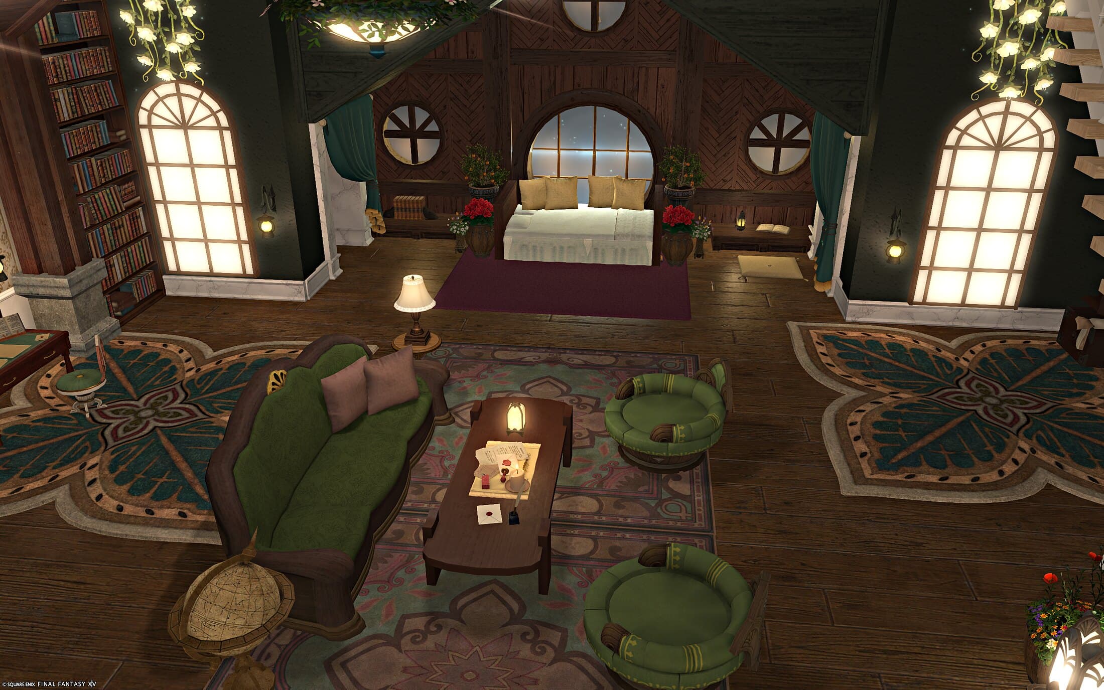 The sofa and coffee table close up, a butterfly-patterned rug underfoot, the bed and its round window glowing at the back of the room