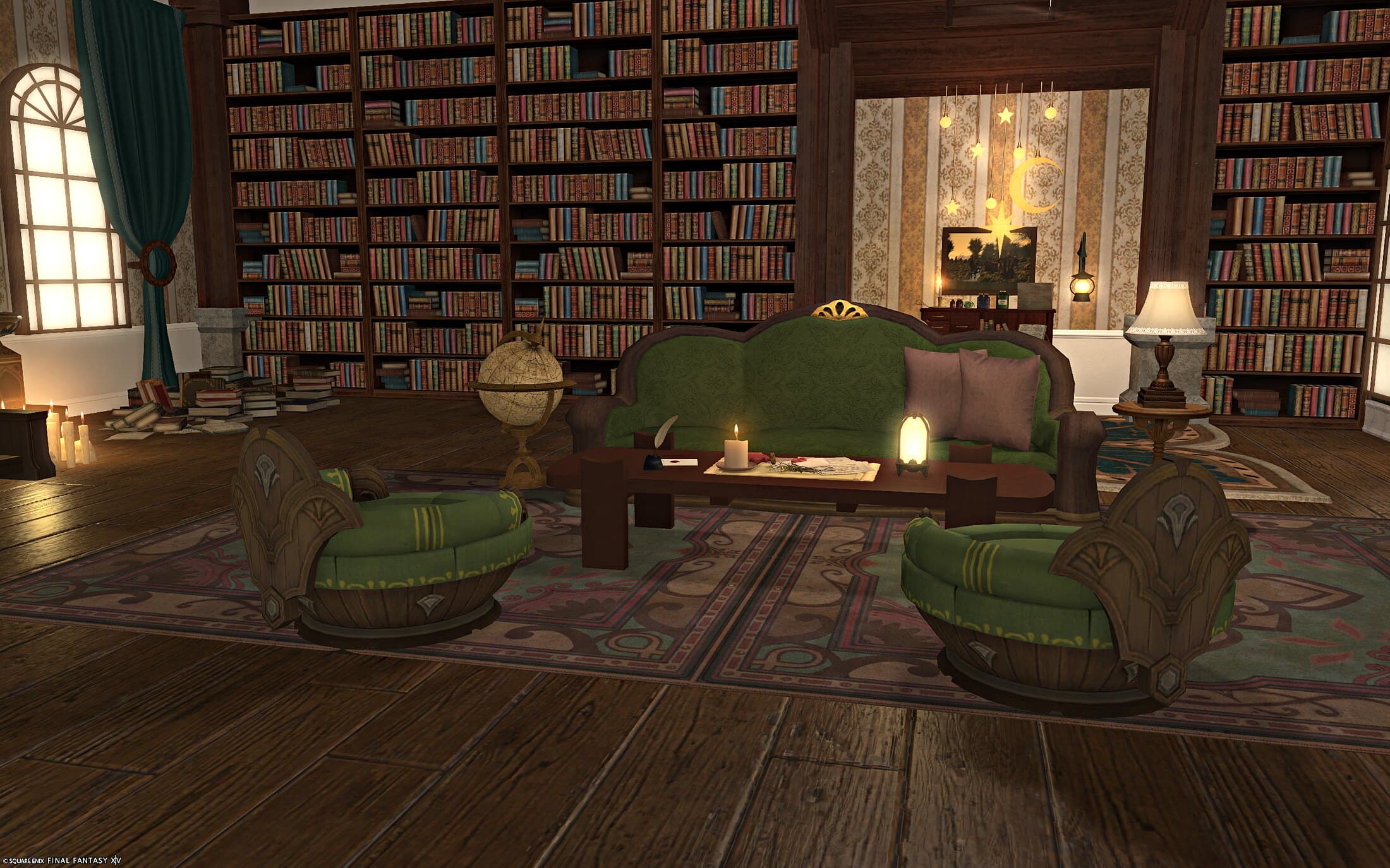A reading nook against the bookshelves — a green sofa and tufted ottomans on a patterned rug, a lamp and a stack of books on the side table, the desk visible behind