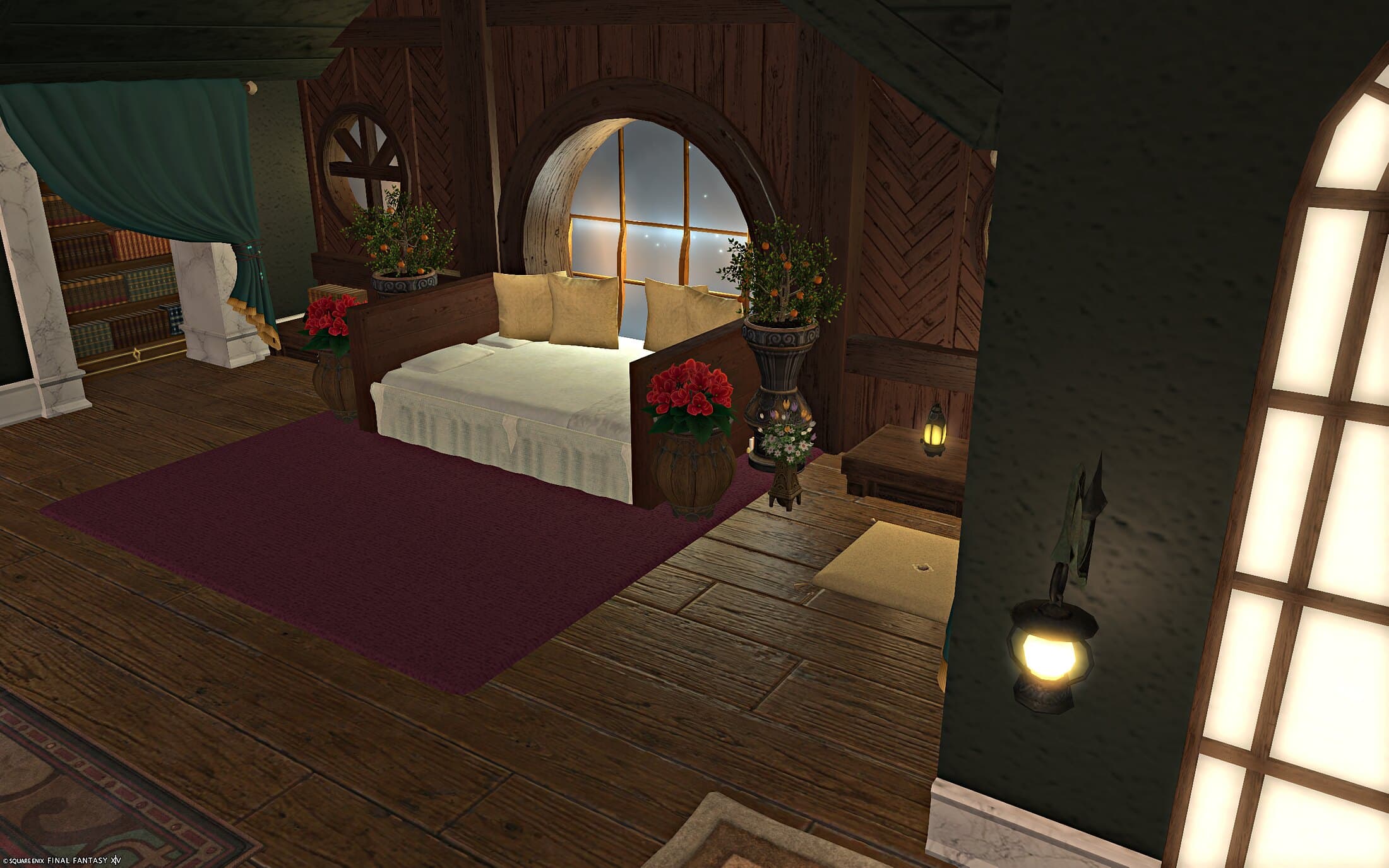 The bed nook seen from the living room side, its round window glowing in the dark teal wall, a lantern lit on the sill of a bookshelf-lined doorway