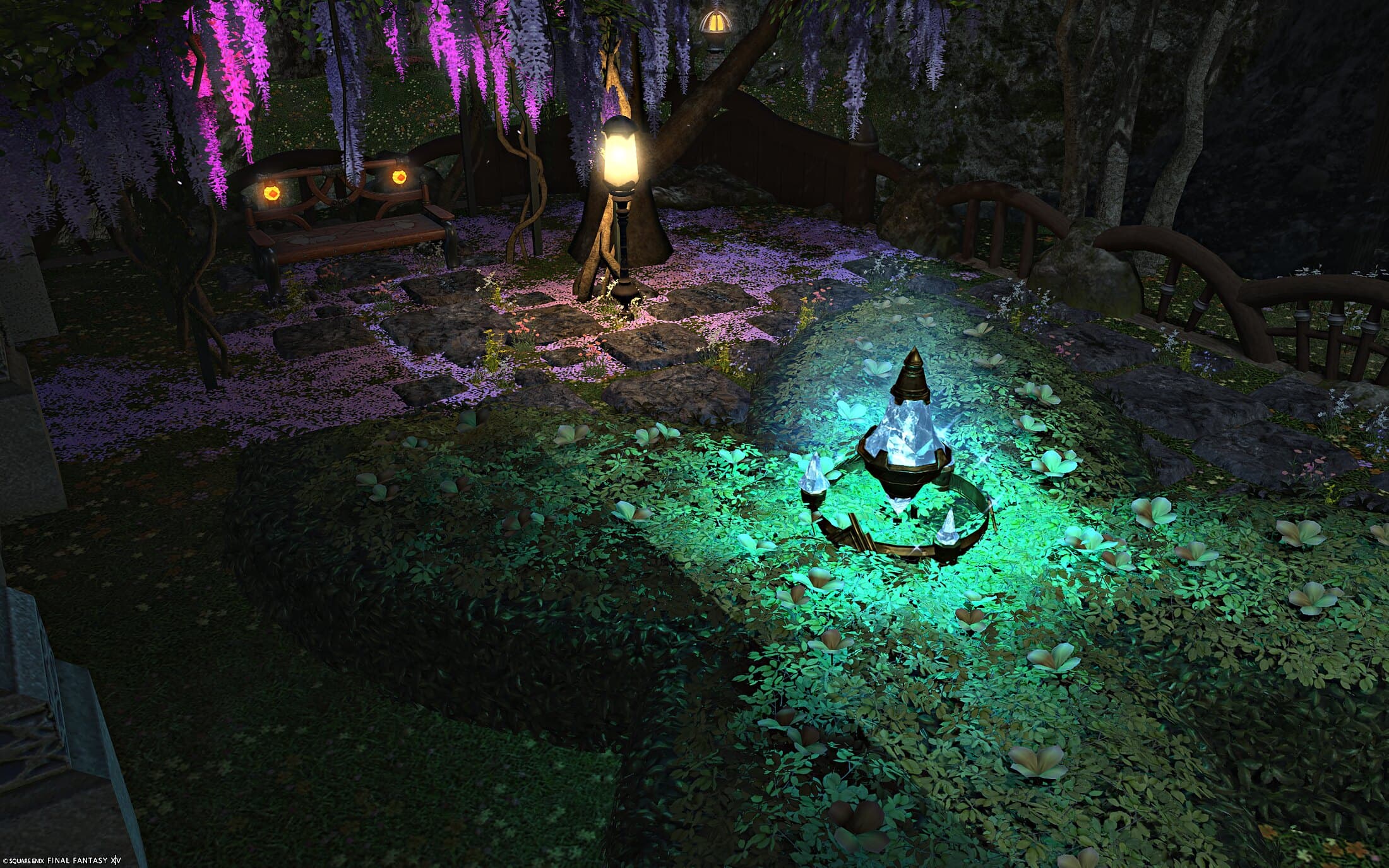 A garden bench and lantern beside the glowing fountain, pink wisteria trailing down from the trees above
