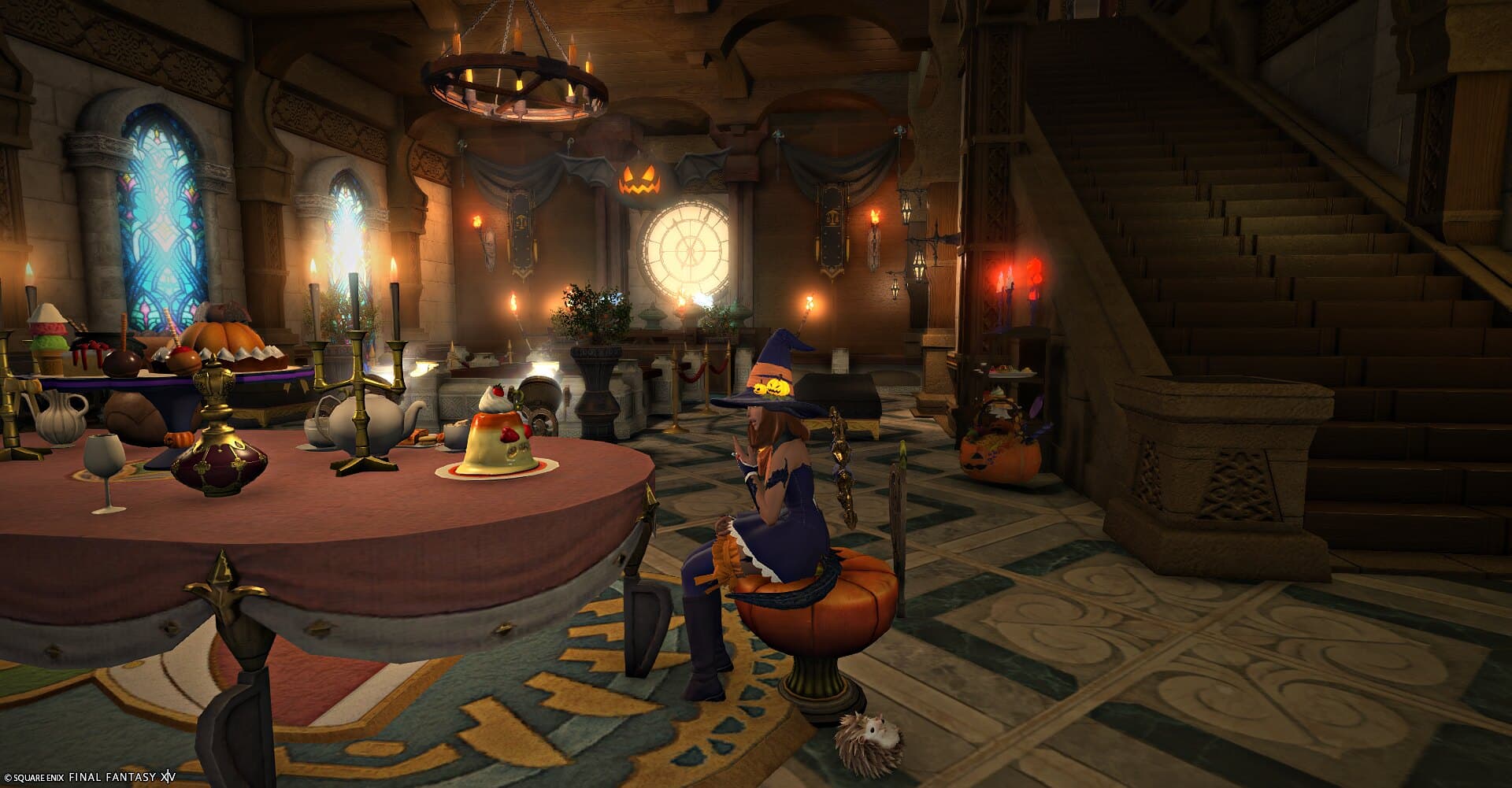 The banquet hall — a long table laid with pumpkins and candles under stained glass, staircase behind