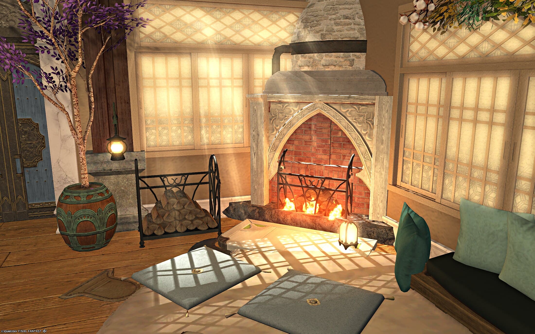 The sitting area's stone fireplace lit and crackling, a wrought-iron log rack beside it, floor cushions and a green-cushioned sofa catching the morning light through lattice windows